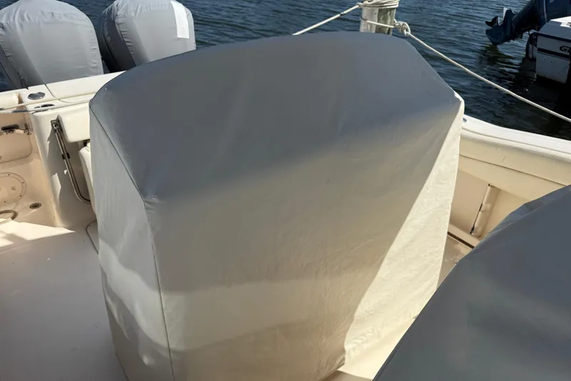  Yacht Photos Pics 2017 Grady-White Canyon 271 FS boat with covered seats and engines by the water.