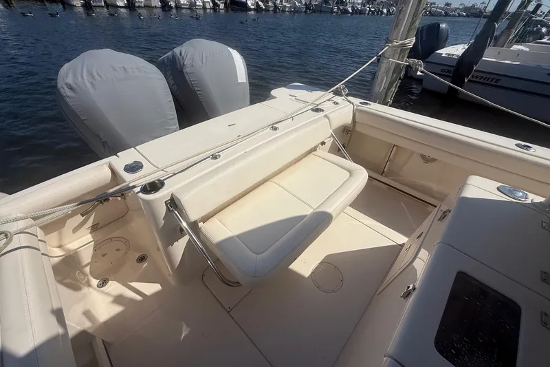  Yacht Photos Pics 2017 Grady-White Canyon 271 FS boat interior with seating and dual engines at a marina.