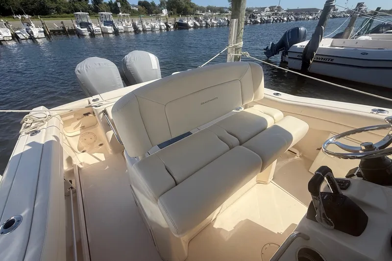  Yacht Photos Pics 2017 Grady-White Canyon 271 FS boat interior with seating and dual engines at a marina.