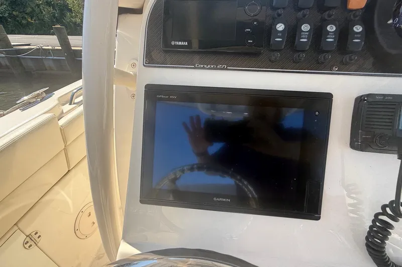  Yacht Photos Pics 2017 Grady-White Canyon 271 FS boat dashboard with Garmin GPS and Yamaha controls.