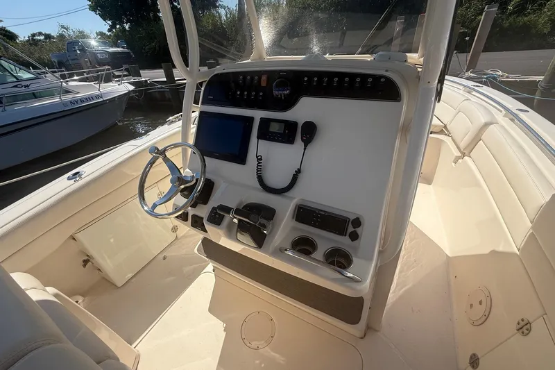  Yacht Photos Pics 2017 Grady-White Canyon 271 FS boat console with steering wheel and navigation equipment.
