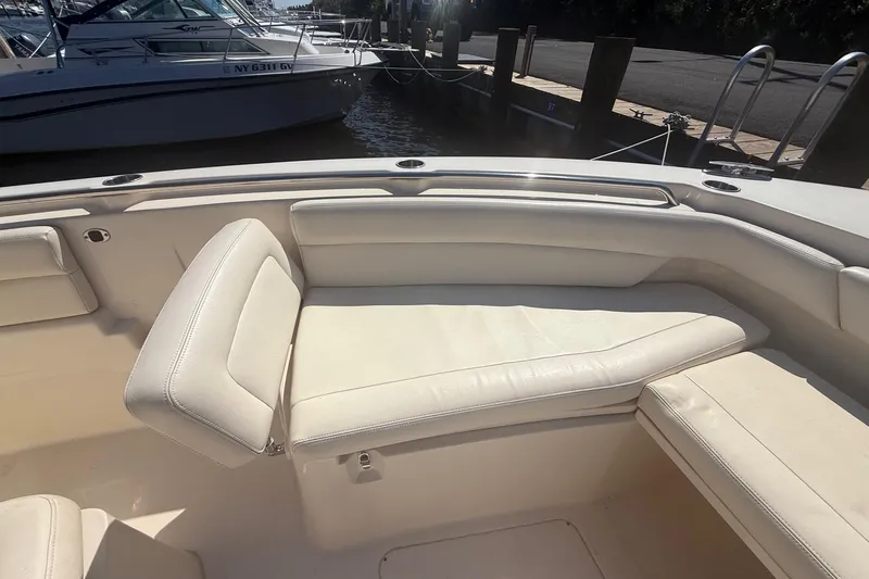  Yacht Photos Pics 2017 Grady-White Canyon 271 FS boat interior with white cushioned seating.