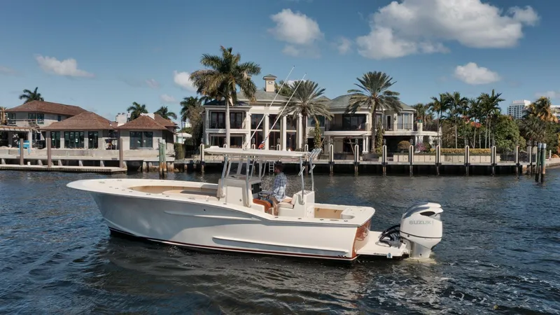 Seabae Yacht Photos Pics 2019 Custom Carolina 30 Open boat cruising near waterfront homes under a clear sky.