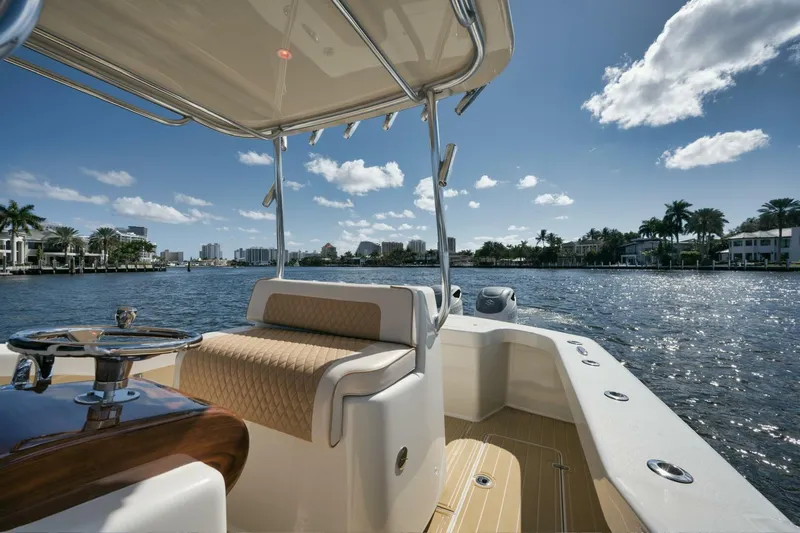 Seabae Yacht Photos Pics 2019 Custom Carolina 30 Open boat on a sunny waterfront, showcasing luxury seating and helm.