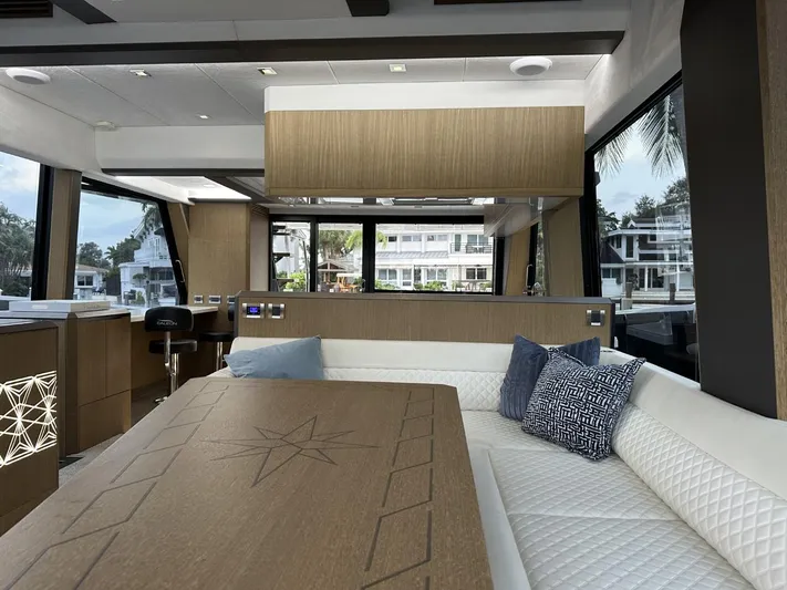  Yacht Photos Pics Luxurious interior of 2019 Galeon 650 Sky yacht with modern seating and large windows.