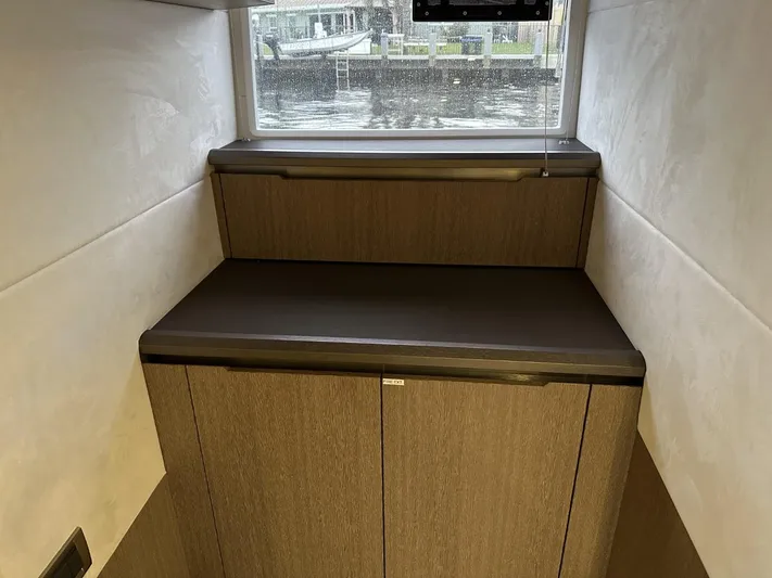  Yacht Photos Pics Interior of 2019 Galeon 650 Sky yacht with wooden cabinetry and window view.