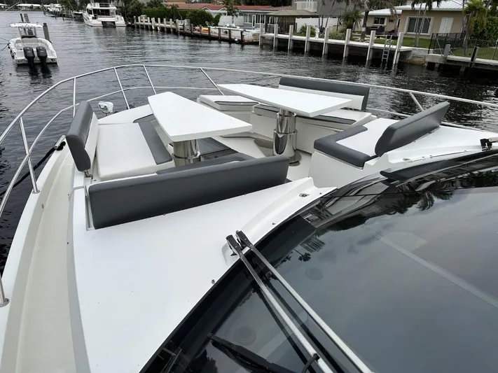  Yacht Photos Pics 2019 Galeon 650 Sky yacht with sleek deck seating and waterfront view.