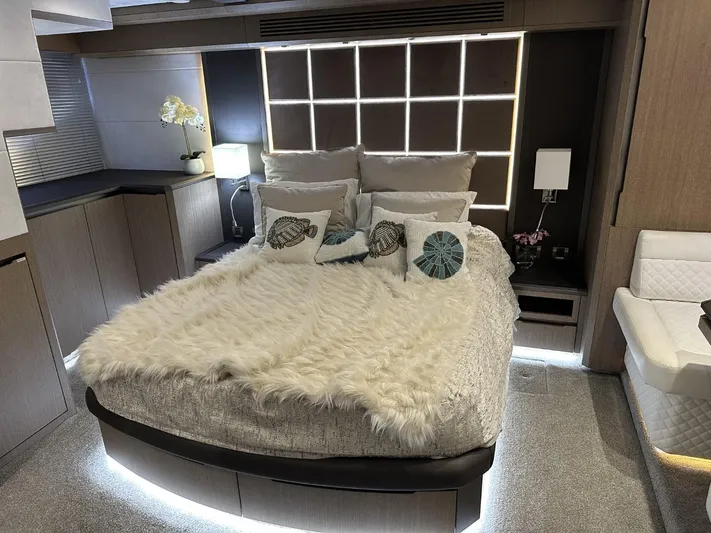  Yacht Photos Pics Luxurious bedroom interior of 2019 Galeon 650 Sky yacht with modern decor and ambient lighting.
