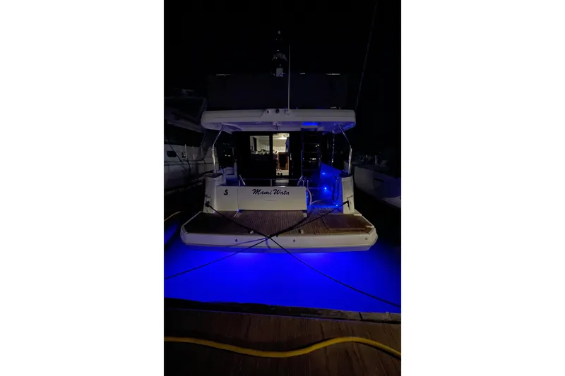  Yacht Photos Pics 2025 Beneteau Swift Trawler 41 Fly with blue underwater lights at night.