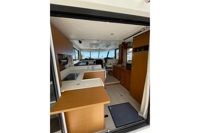  Yacht Photos Pics Interior view of 2025 Beneteau Swift Trawler 41 Fly, featuring modern kitchen and seating area.