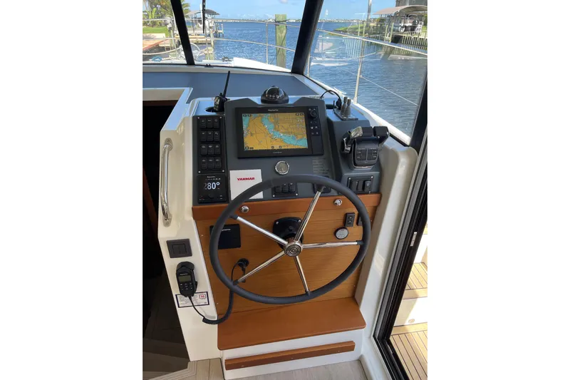  Yacht Photos Pics Helm of 2025 Beneteau Swift Trawler 41 Fly with navigation equipment and steering wheel.