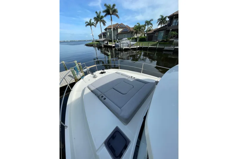  Yacht Photos Pics 2025 Beneteau Swift Trawler 41 Fly docked, featuring spacious deck and scenic waterfront view.