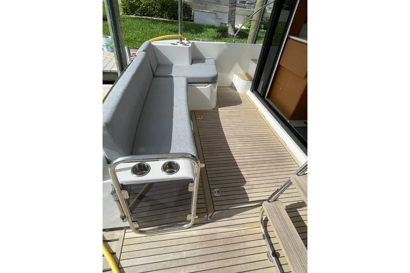  Yacht Photos Pics 2025 Beneteau Swift Trawler 41 Fly deck with seating and wooden flooring.