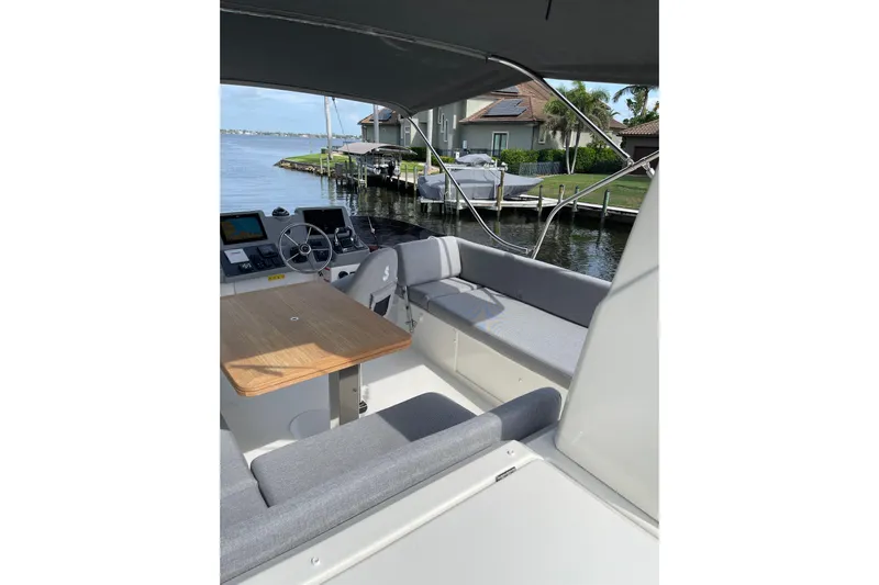  Yacht Photos Pics 2025 Beneteau Swift Trawler 41 Fly, featuring a spacious flybridge with seating and helm.