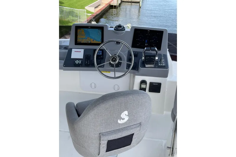  Yacht Photos Pics 2025 Beneteau Swift Trawler 41 Fly helm with navigation screens and steering wheel.