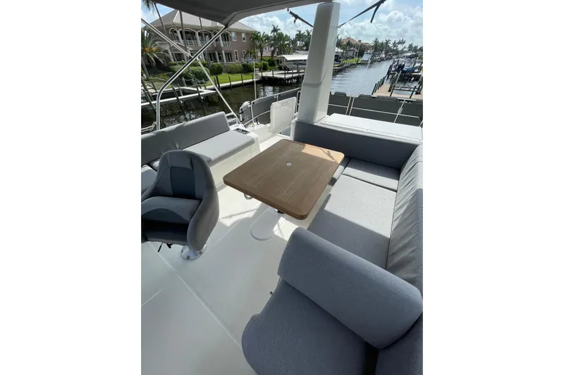  Yacht Photos Pics Flybridge seating area on 2025 Beneteau Swift Trawler 41 Fly, featuring a table and cushioned seats.
