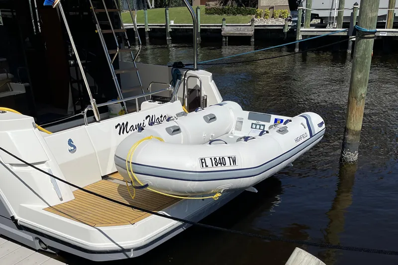  Yacht Photos Pics 2025 Beneteau Swift Trawler 41 Fly with inflatable dinghy docked at marina.