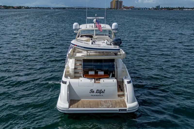 To Life! Yacht Photos Pics 2005 Azimut Fly 62 yacht on open water, rear view, with American flag.