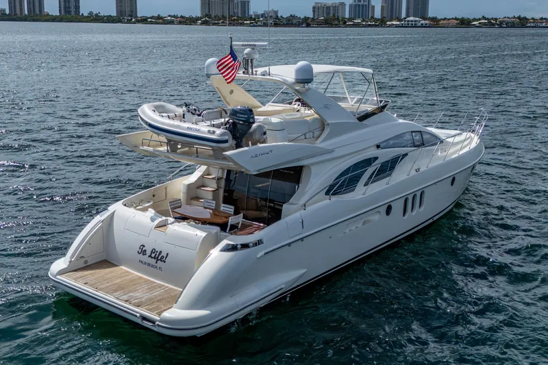 To Life! Yacht Photos Pics 2005 Azimut Fly 62 yacht cruising on open water, featuring a sleek design and luxury amenities.