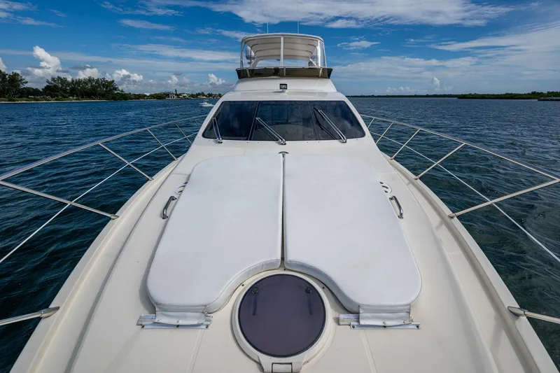 To Life! Yacht Photos Pics 2005 Azimut Fly 62 yacht on open water, showcasing sleek design and spacious deck.