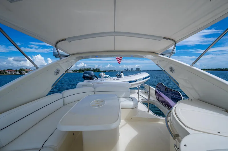 To Life! Yacht Photos Pics Luxurious 2005 Azimut Fly 62 yacht interior with ocean view and tender boat.