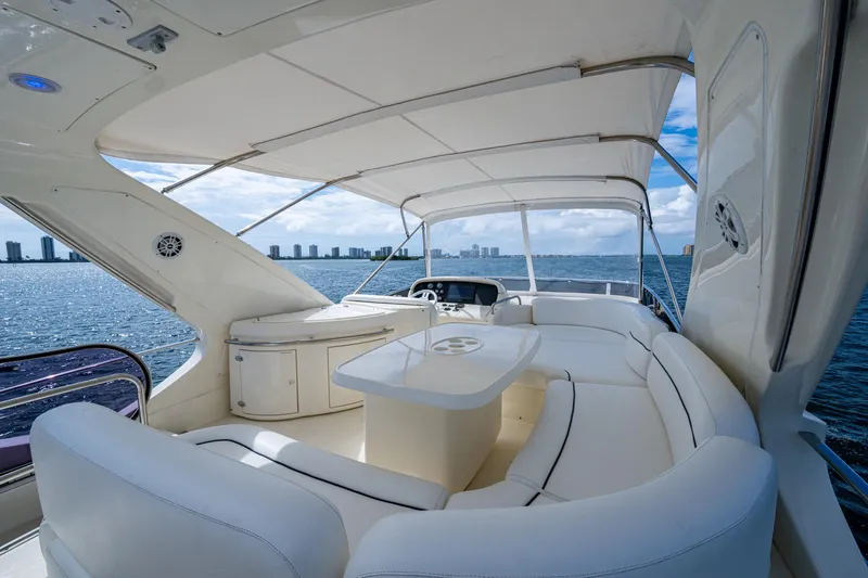 To Life! Yacht Photos Pics Luxurious 2005 Azimut Fly 62 yacht interior with white seating and ocean view.