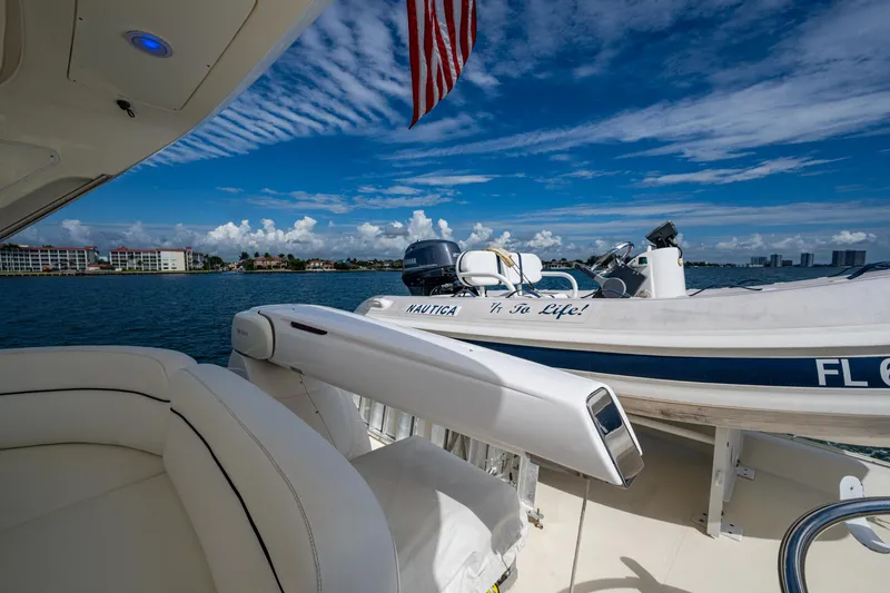 To Life! Yacht Photos Pics Azimut Fly 62 yacht, 2005 model, with inflatable boat on deck, under clear blue sky.