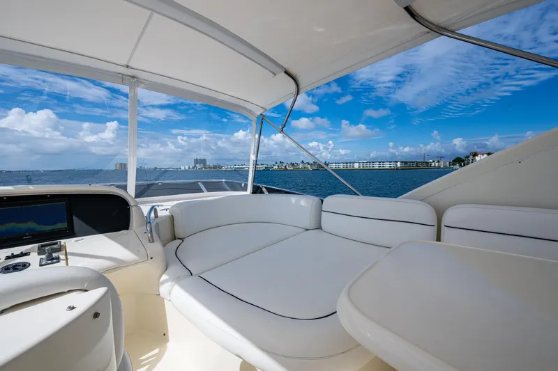 To Life! Yacht Photos Pics Luxurious 2005 Azimut Fly 62 yacht interior with ocean view and comfortable seating.