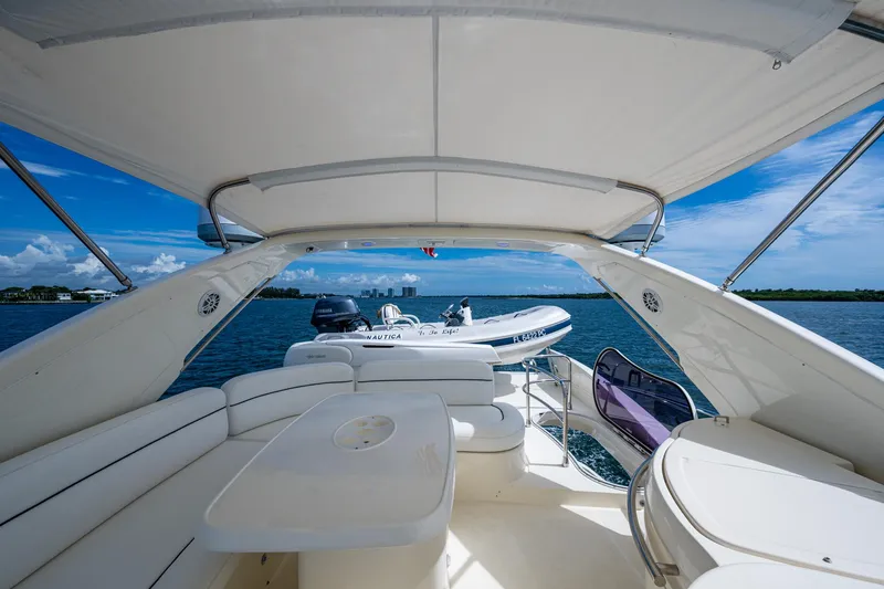 To Life! Yacht Photos Pics Luxurious 2005 Azimut Fly 62 yacht interior with seating, table, and ocean view.