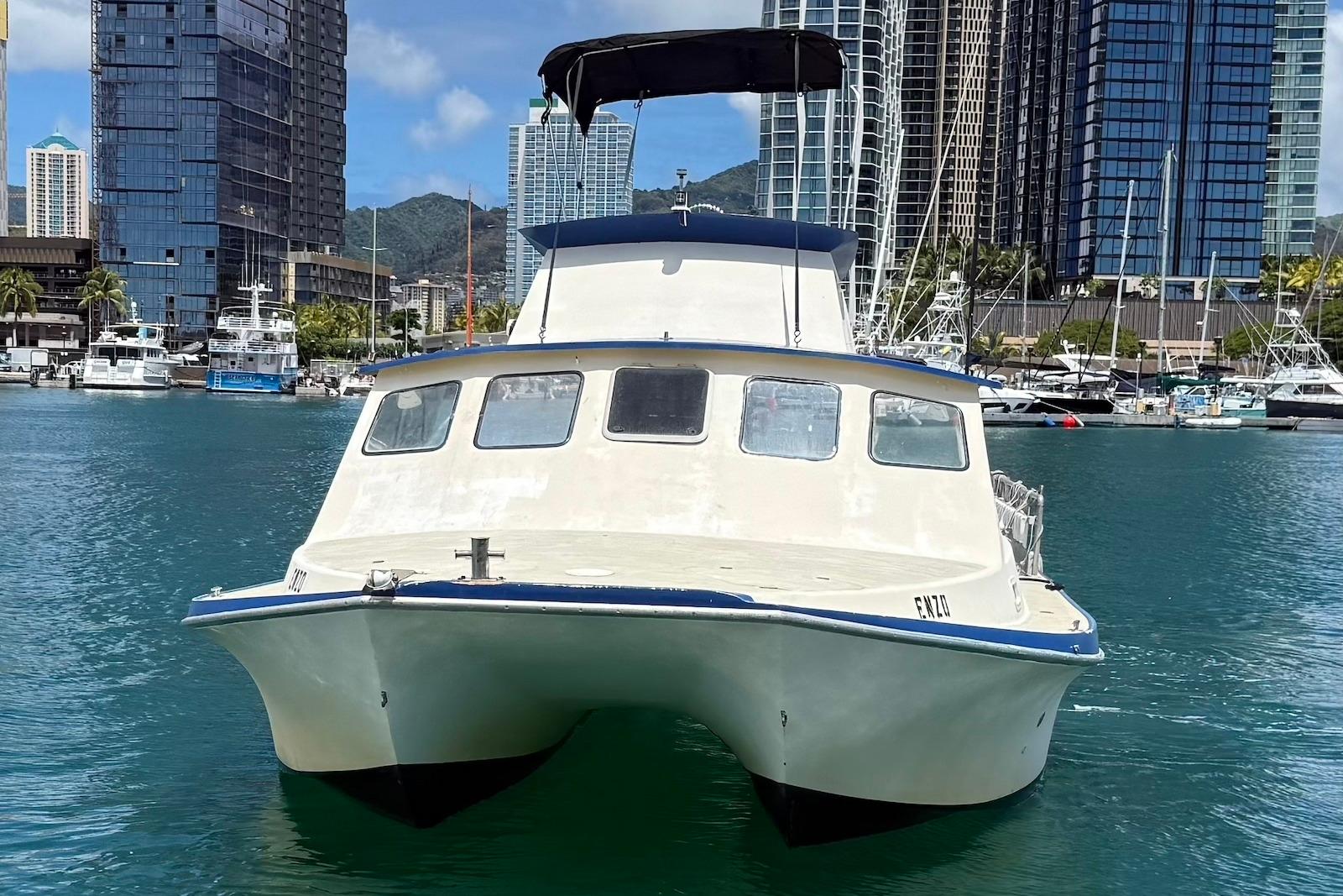 2001 Force Power Cat boat docked in urban marina with skyscrapers in background.
