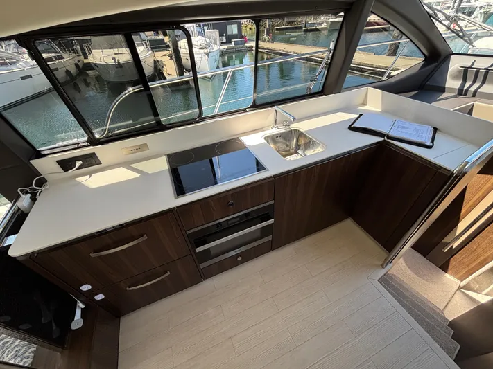 Skye Yacht Photos Pics Modern kitchen interior of 2019 Azimut Fly 50 yacht with sleek design and marina view.