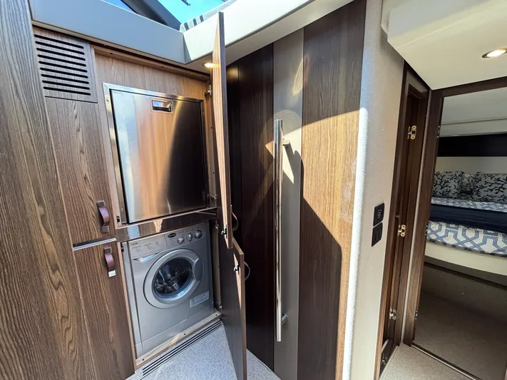 Skye Yacht Photos Pics 2019 Azimut Fly 50 yacht interior with built-in washer and dryer, wooden cabinetry, and modern design.