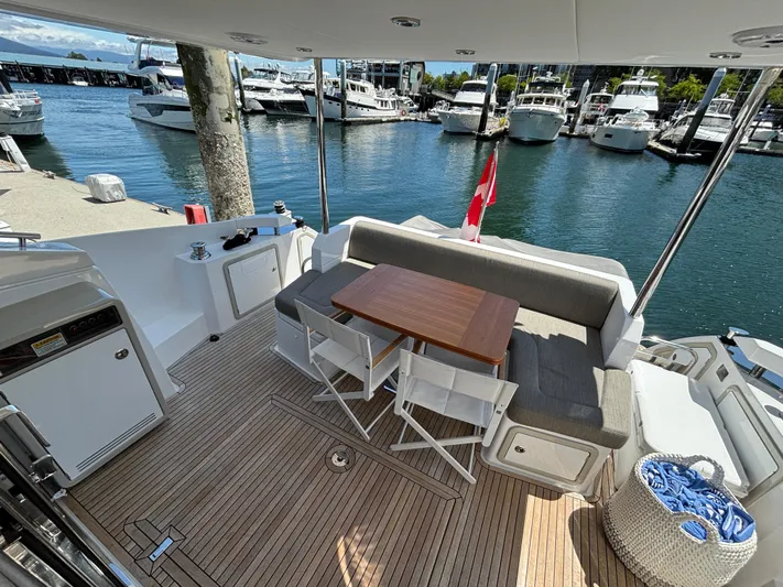 Skye Yacht Photos Pics Azimut Fly 50 yacht deck with seating, table, and marina view, 2019 model.