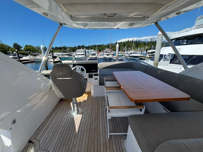 Skye Yacht Photos Pics 2019 Azimut Fly 50 yacht interior with seating and table, docked at marina.