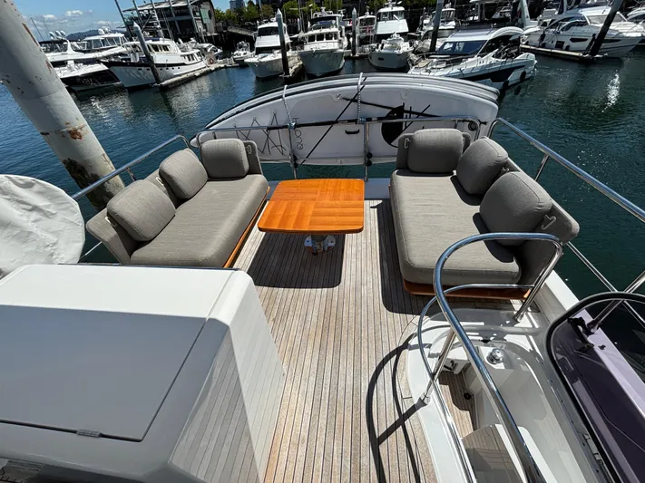 Skye Yacht Photos Pics Luxurious 2019 Azimut Fly 50 yacht deck with comfortable seating and wooden table.
