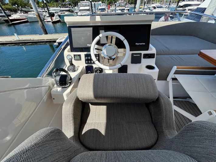 Skye Yacht Photos Pics Cockpit of 2019 Azimut Fly 50 yacht with steering wheel and navigation equipment.