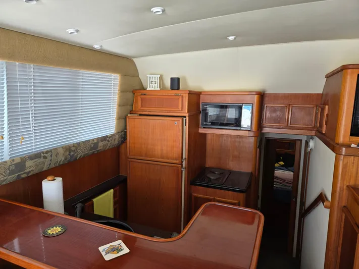 Bad To The Bone Yacht Photos Pics Interior of 1995 Egg Harbor Golden Egg 42 yacht with wooden cabinetry and modern appliances.