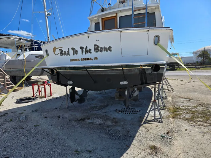 Bad To The Bone Yacht Photos Pics 1995 Egg Harbor Golden Egg 42 boat on stands, "Bad To The Bone" text, Punta Gorda, FL.