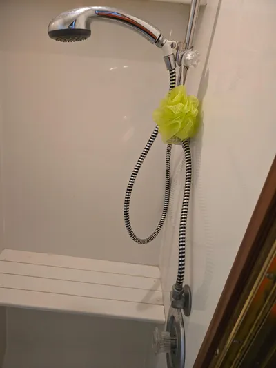 Bad To The Bone Yacht Photos Pics Shower area in 1995 Egg Harbor Golden Egg 42 boat with handheld showerhead.