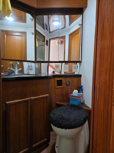 Bad To The Bone Yacht Photos Pics 1995 Egg Harbor Golden Egg 42 yacht bathroom with wood cabinetry and mirrored vanity.