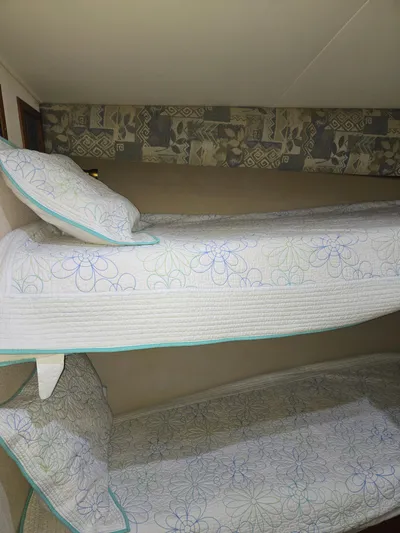 Bad To The Bone Yacht Photos Pics Bunk beds with floral bedding inside a 1995 Egg Harbor Golden Egg 42 yacht.