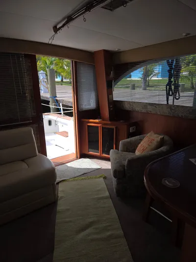 Bad To The Bone Yacht Photos Pics Interior of 1995 Egg Harbor Golden Egg 42 yacht with cozy seating and outdoor view.