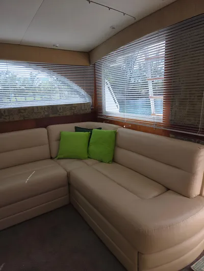 Bad To The Bone Yacht Photos Pics Luxurious beige seating with green cushions in 1995 Egg Harbor Golden Egg 42 yacht interior.