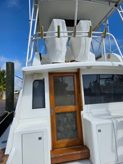 Bad To The Bone Yacht Photos Pics 1995 Egg Harbor Golden Egg 42 yacht with wooden door and covered upper deck.