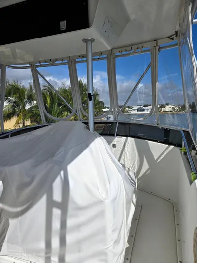 Bad To The Bone Yacht Photos Pics 1995 Egg Harbor Golden Egg 42 boat interior with covered equipment and clear windows overlooking water.