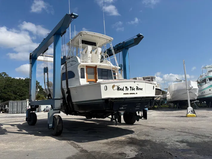 Bad To The Bone Yacht Photos Pics 1995 Egg Harbor Golden Egg 42 yacht on lift, clear sky background.