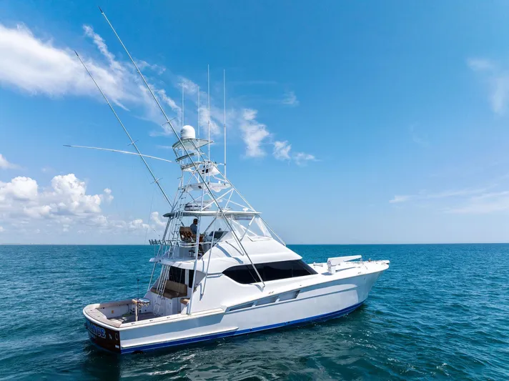Endurance Yacht Photos Pics 1998 Hatteras 60 Convertible yacht cruising on open sea under clear blue sky.