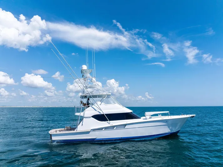 Endurance Yacht Photos Pics 1998 Hatteras 60 Convertible yacht cruising on open sea under clear blue sky.
