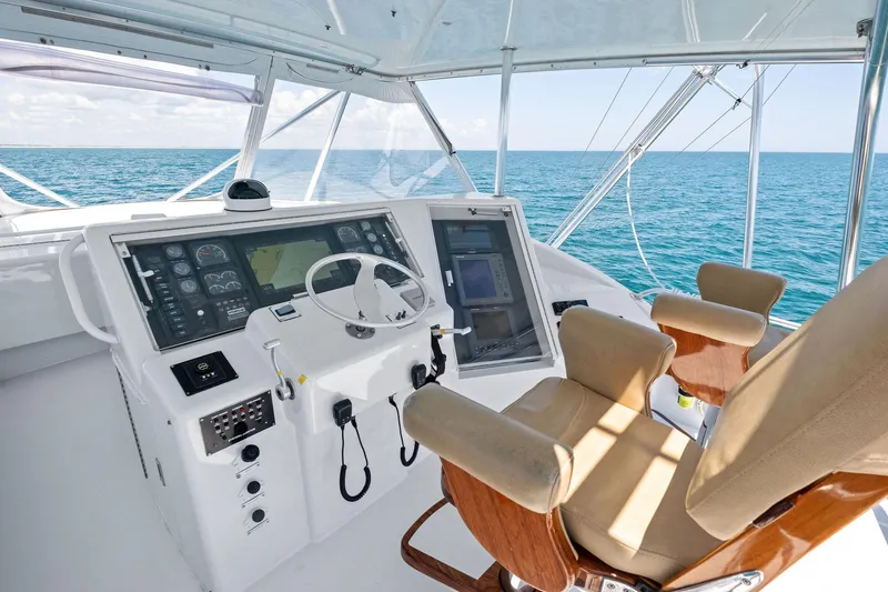 Endurance Yacht Photos Pics Helm of 1998 Hatteras 60 Convertible yacht with ocean view and modern controls.