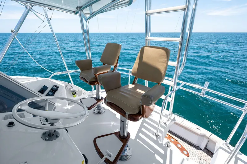 Endurance Yacht Photos Pics Flybridge of 1998 Hatteras 60 Convertible yacht with ocean view and helm chairs.
